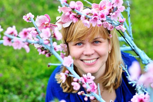 happy woman in spring blossom garden