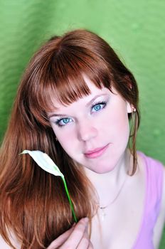 portrait of redheaded pretty girl with white flower
