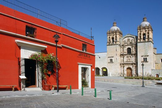 View of cathedral and red house in Oaxaca city in Mexico