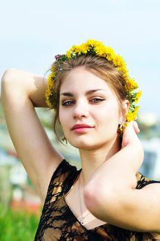   portrait of pretty teen girl with dandelion garland
