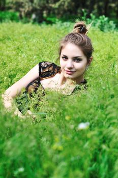 tender teen girl sitting in the grass