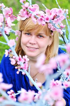  happy forty years woman in spring blossom garden
