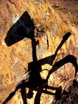 shadow of bike on rocks in evening sun