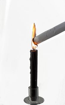 Black candle burning for destroying a white paper