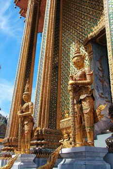 The statues of giant standing in the area of the Wat Phra Kaeo temple, Bangkok, Thailand.