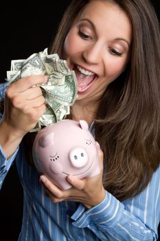 Woman saving money in piggy bank