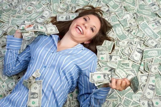 Beautiful woman laying in money
