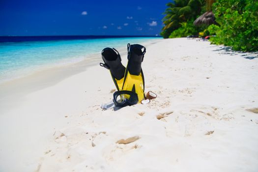 snorekl equipment on white sand beach at Maldives