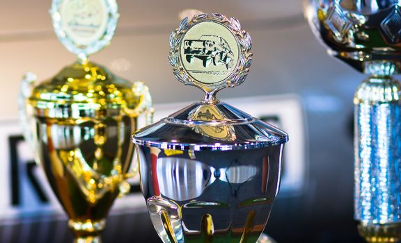 Trophy for car race winning or medal on background with a Automobile