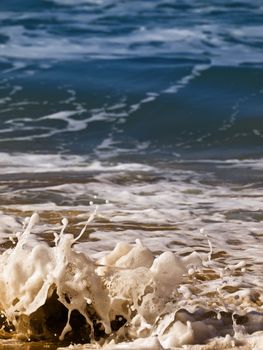 Waves crashing on the coast on a beach in Malta