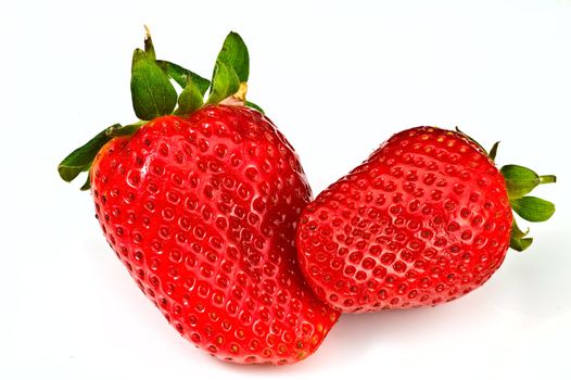 Two fresh ripe strawberries on white background