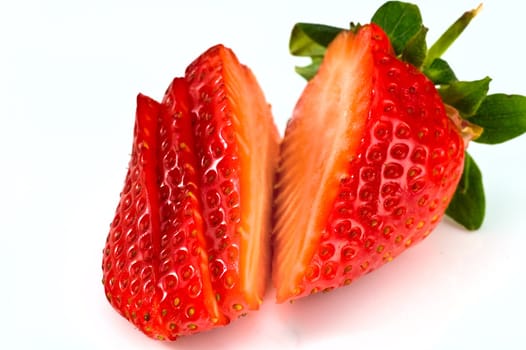 Fresh ripe strawberry cutted into pieces on white background