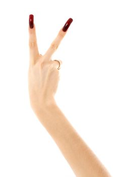 hand with long acrylic nails showing victory sign over white