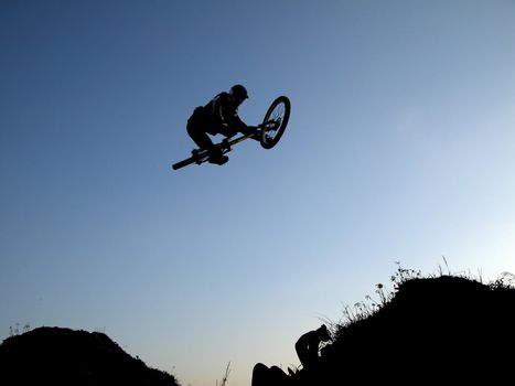 Boy riding a bike and making a big jump