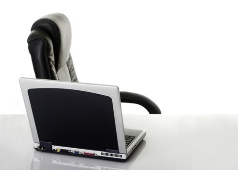 Work office with a chair and laptop over the table