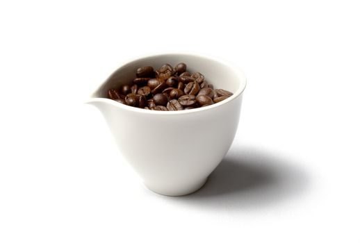 white porcelain cup full of colombian coffee beans