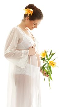 beautiful pregnant woman with yellow lily over white