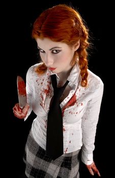 angry schoolgirl with bloody knife over black