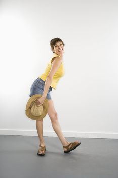 Portrait of pretty Caucasian woman in summer attire posing playfully.