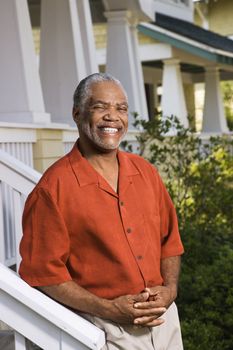 African American middle aged man smiling at viewer.