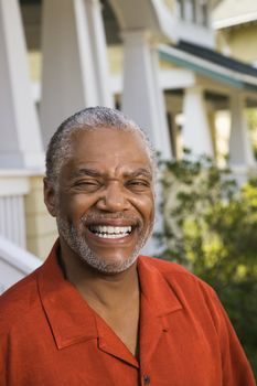 African American middle aged man smiling at viewer.