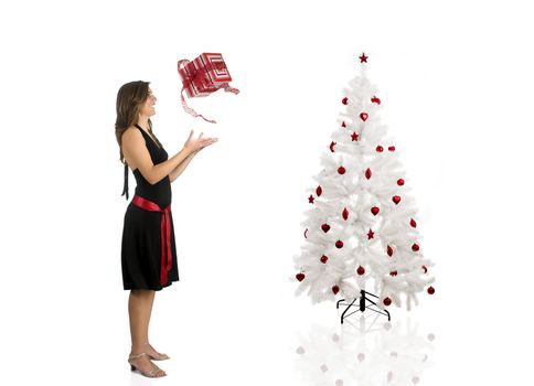 Beautiful Woman wiht a gift and a Christmas tree