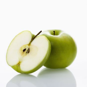 Still life of green apples on white background.