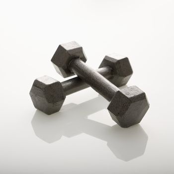 Two dumbbells leaning together.