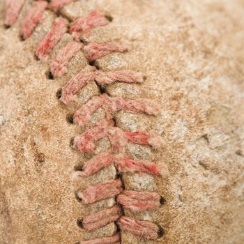 Detail of stitching on dirty worn baseball.