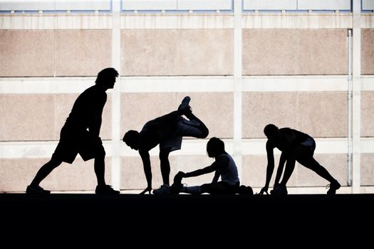 Group of runners stretching before race.