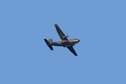 Military propeller aircraft flying in a clear skies