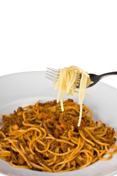 fork over a plate with spaghetti bolognaise
