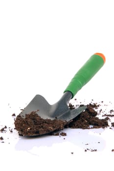 garden tools shovel and soil on white background