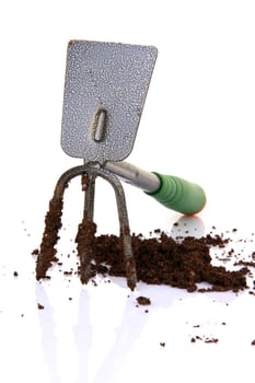 gardening tools weeder hoe and soil isolated on white background