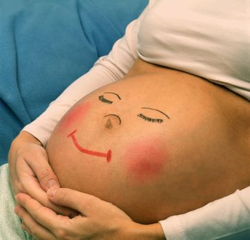 Pregnant belly with picture of funny face