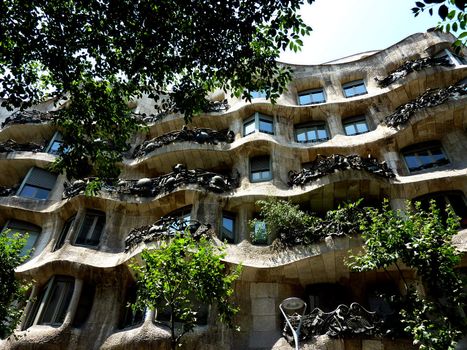 Facade of Casa Mila with all its black sculptured balconies, Barcelona, Spain