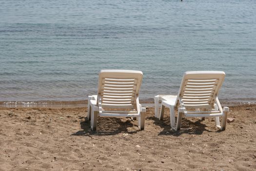 two white beach chairs by the sea patmos island greece