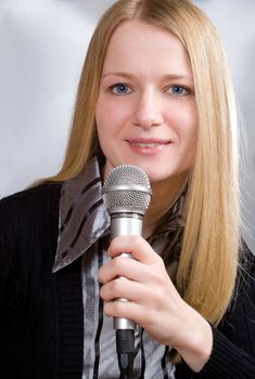 portrait of young woman singing into microphone