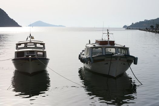 two wooden boats moored at harbor of skala patmos greece