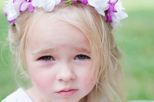 Little girl portrait with wreath, outdoor shooting