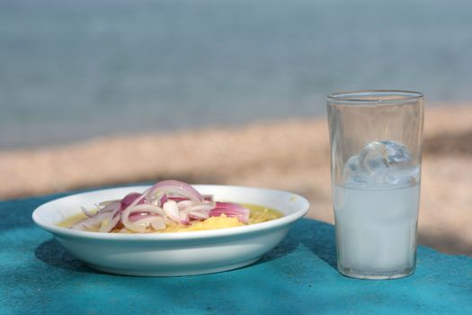 closeup greek traditional food fava with glass of ouzo by the sea with copyspace