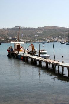 fishing boats and wooden dock at patmos island dodecanece greece