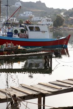 fishing boats wooden docks at patmos island dodecanece greece