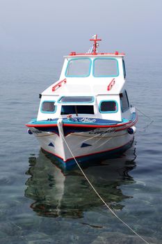 colorful traditional greek small wooden fishing boat moored