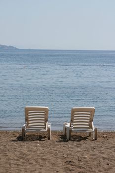 two white beach chairs by the sea patmos island greece