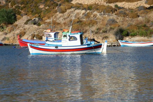 traditional greek fishing boats at harbor