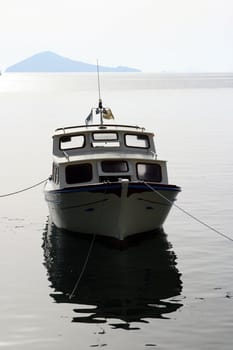 small wooden fishing boat anchored sunset 