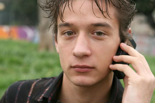 young man talking with cell phone outdoors