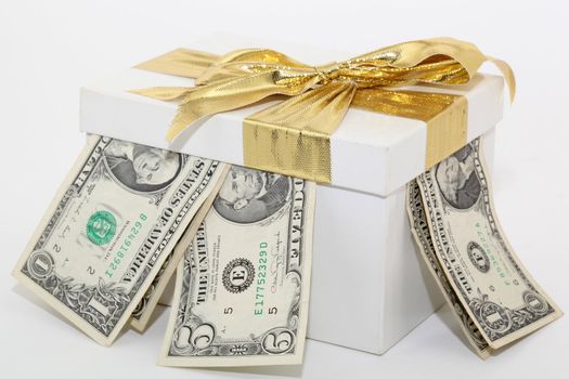 expensive white gift box with gold ribbon and bow and dollars