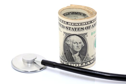 expensive health treatment stethoscope and dollars rolled